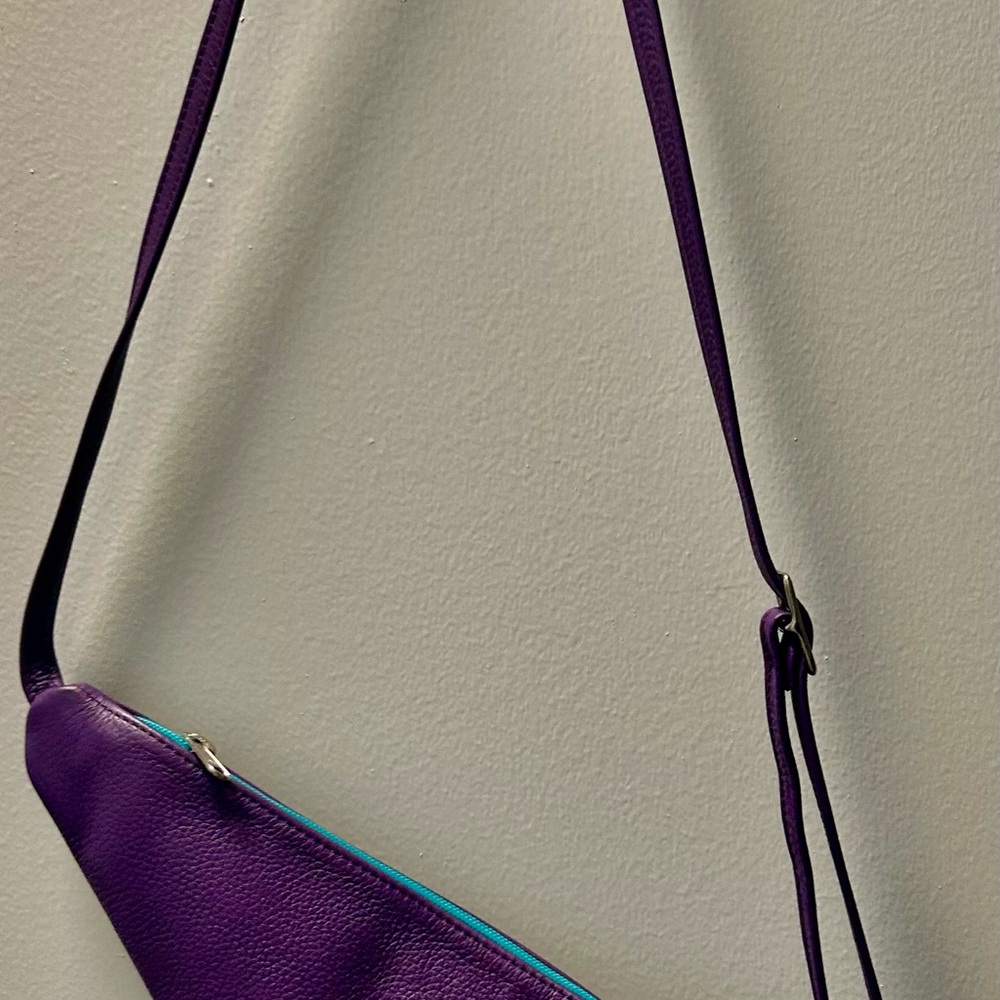 Elegant Purple Leather Crossbody Bag with teal and green accents.